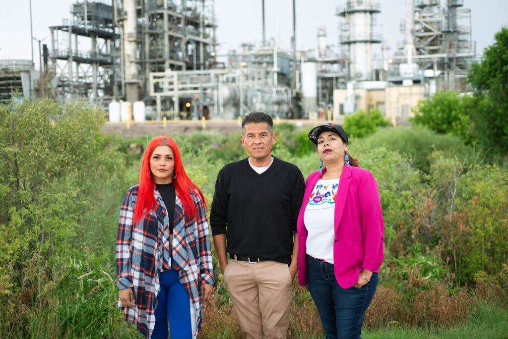 North Denver community members, Lissa Leticia de Gonzales, Jose Molina and Lucy Molina, left to right, near the Suncor Refinery, which is heavily polluting their neighborhoods. (Carmel Zucker for Earthjustice)