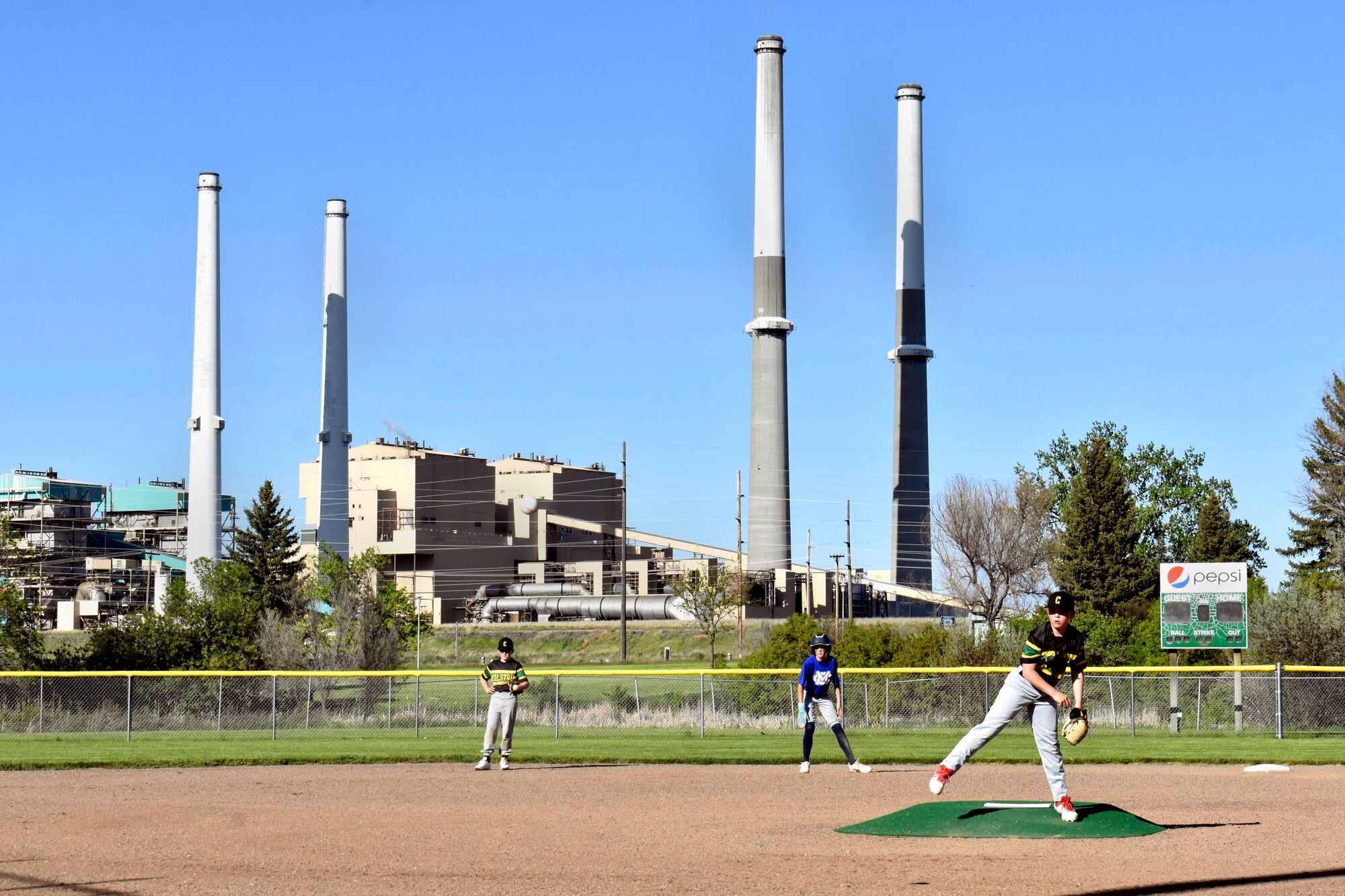 Colstrip Generating Station The coal-fired Colstrip Generating Station is seen behind youths playing baseball in Colstrip, Montana.