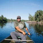 Boundary Waters guide Dave Hicks paddling his canoe through the wilderness area.