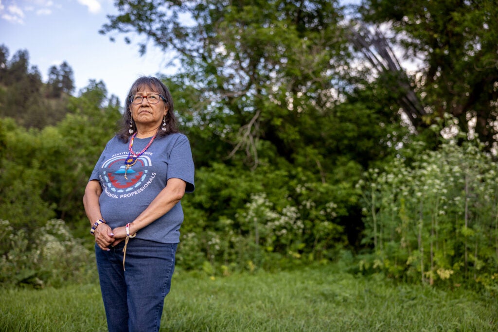 Charlene Alden stands outside her home in Lame Deer, Montana on July 2, 2025. Alden is the Environmental Protection Director for the Northern Cheyenne Tribe. (Louise Johns for Earthjustice)