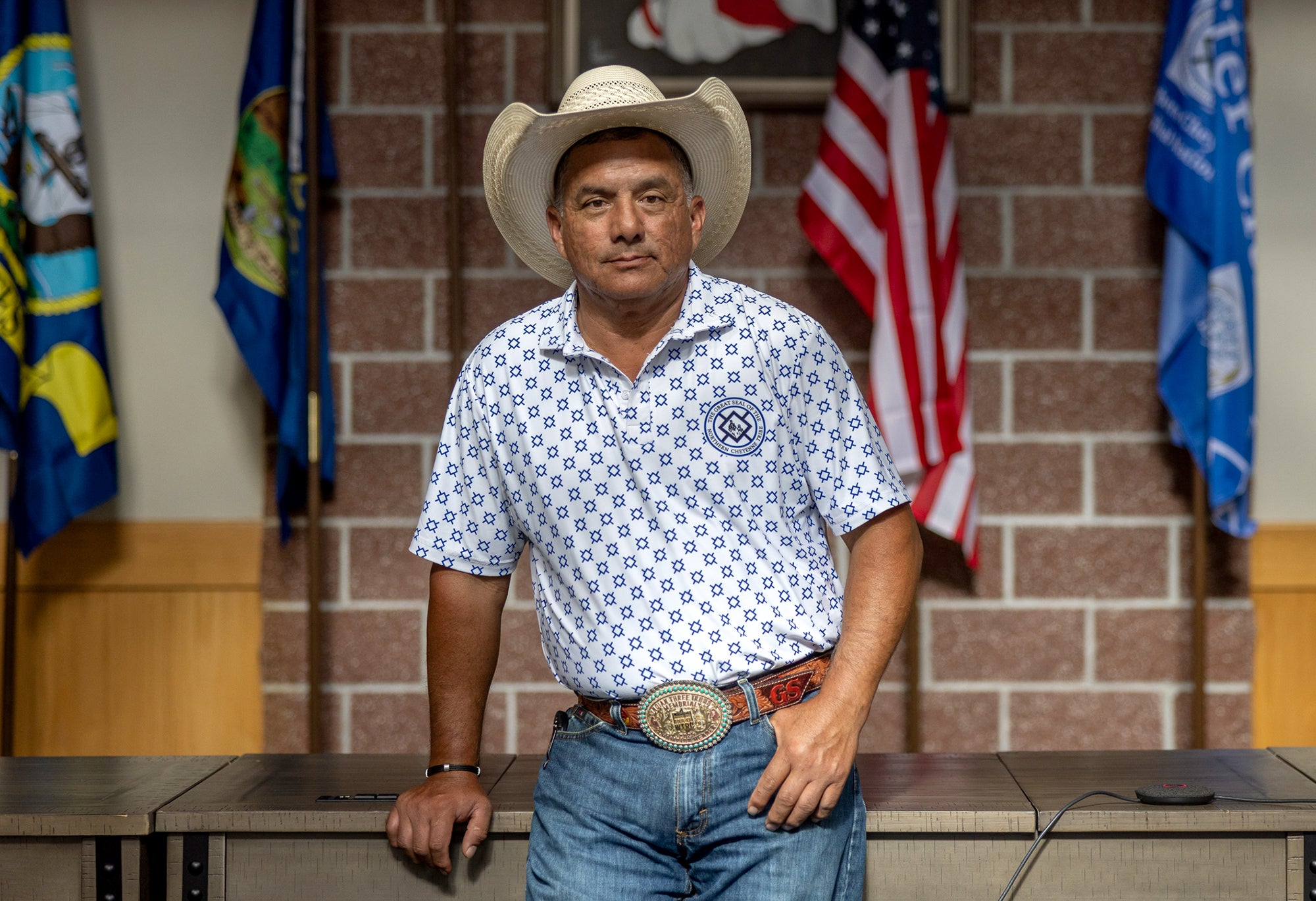 Gene Small, the President of the Northern Cheyenne Tribe, stands in the flag room of the tribal headquarters in Lame Deer. 