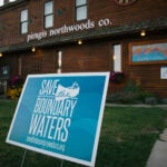 Save the Boundary Waters sign outside of Piragis Northwoods Co., a large outfitter in Ely, Minnesota.