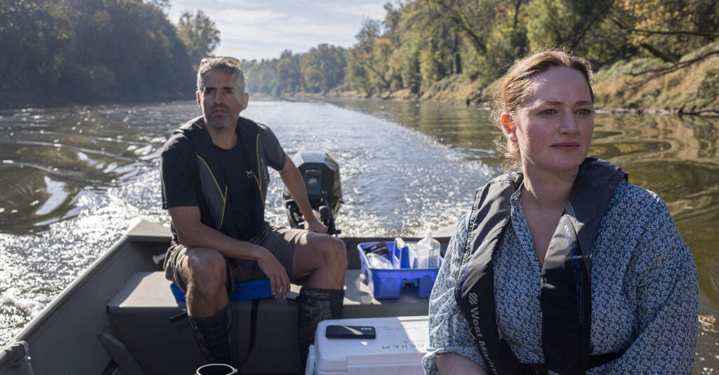 Cape Fear Riverkeeper Kemp Burdette and Earthjustice attorney Alexis Andiman collect water samples in the Cape Fear River near the Smithfield slaughterhouse in Tar Heel, North Carolina, October 2023. We’ve successfully pushed the EPA to propose rules that, if implemented, would prevent nearly 100 million pounds of slaughterhouse pollution from reaching U.S. waters each year. (Justin Cook for Earthjustice)
