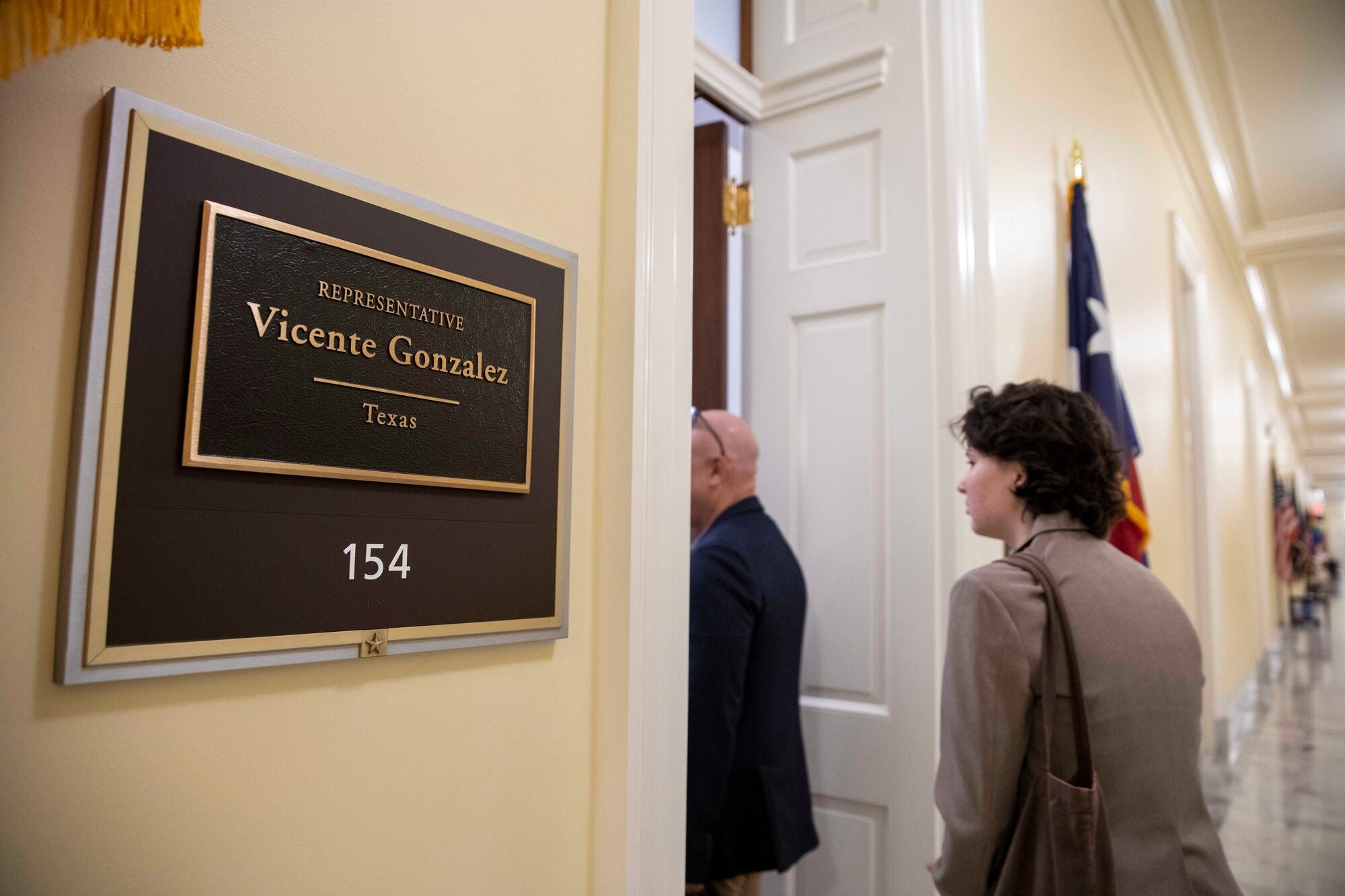 Farm Bill 2023 Lobby Day on Capitol Hill Two people walk through a doorway into an office with a sign outside that reads: "Representative Vincente Gonzalez, Texas, 154."