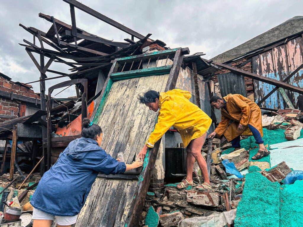 A family salvages belongings from the rubble of their home after it collapsed during Hurricane Melissa's passage through Cuba on October 29, 2025. (Photo by YAMIL LAGE / AFP) (Photo by YAMIL LAGE/AFP via Getty Images)