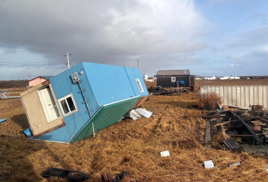 A house rests on its roof after a huge storm in Kotlik, Alaska, on Oct. 12, 2025.