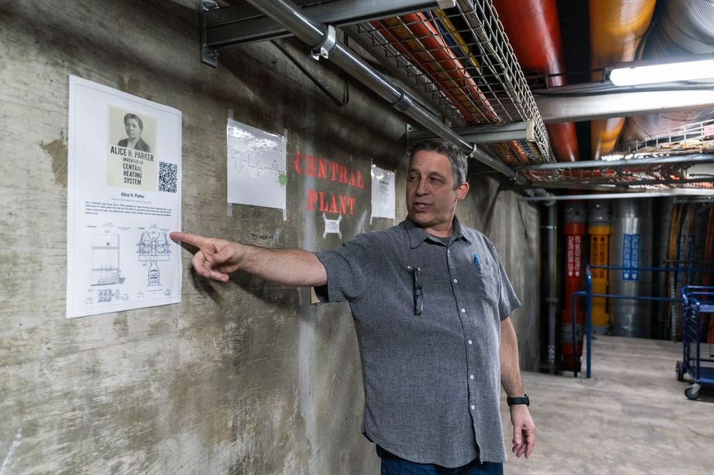 Employee at California State University Dominguez Hills points to poster of Alice H Parker