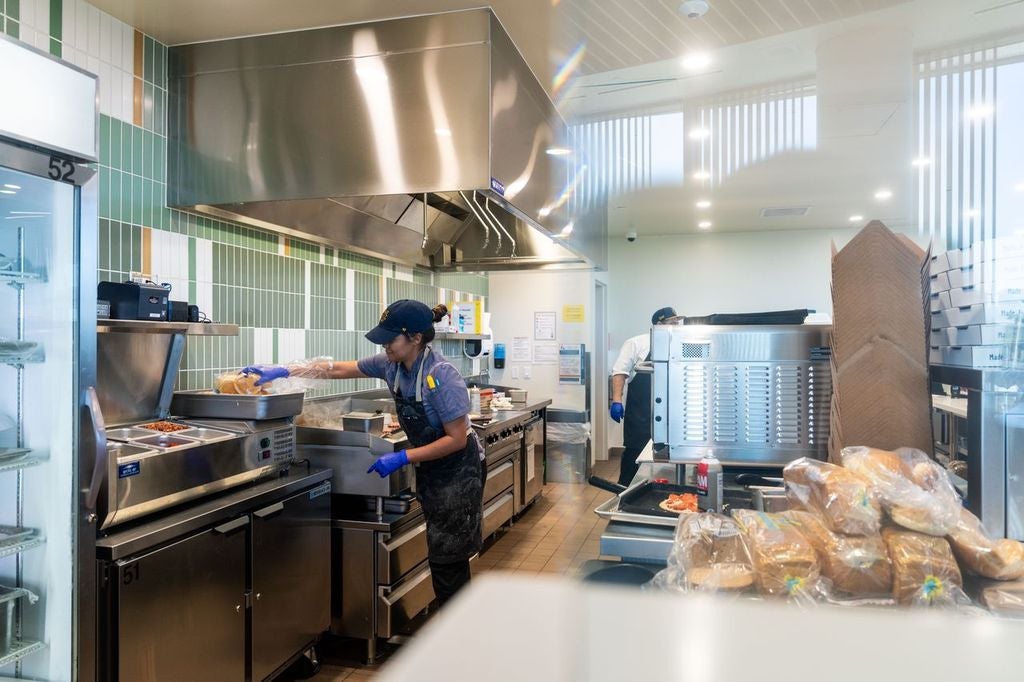 Person standing in front of induction stove preparing food