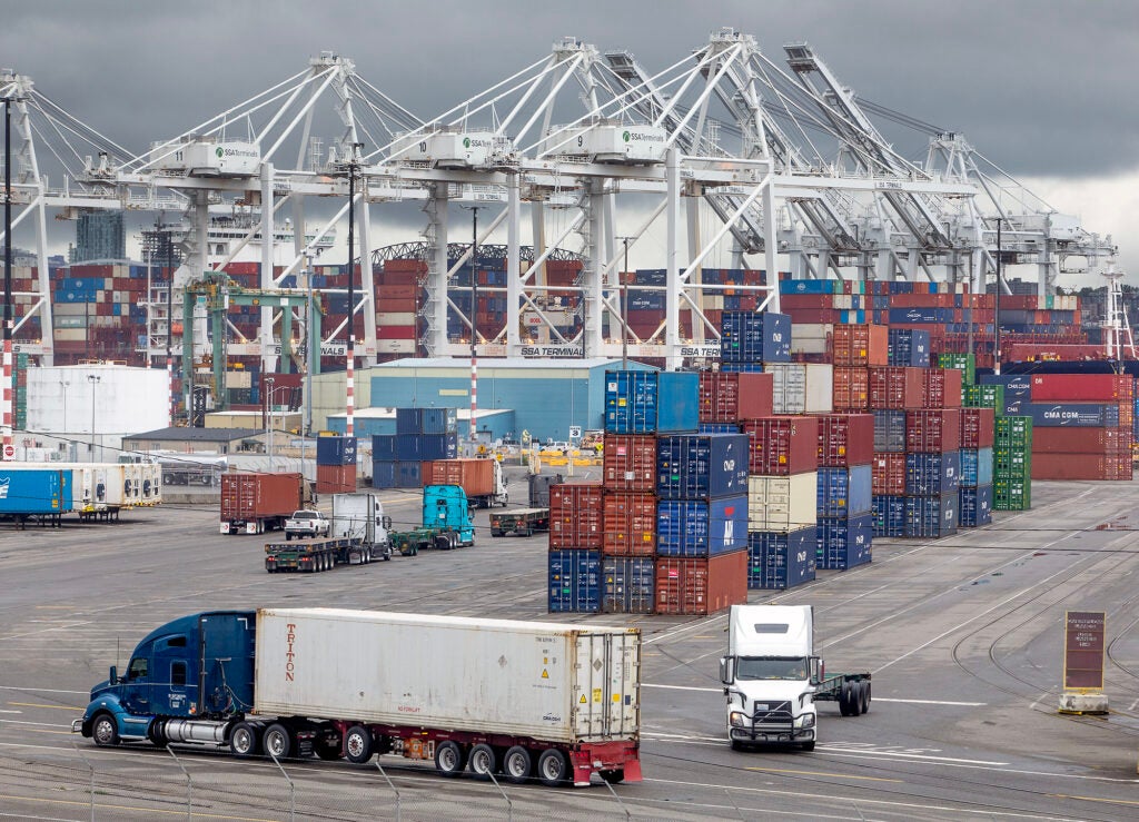 Semi trucks line up to receive containers as a ship is unloaded at a Port of Seattle terminal in Seattle, Washington. (Matthew Brashears / Getty Images)