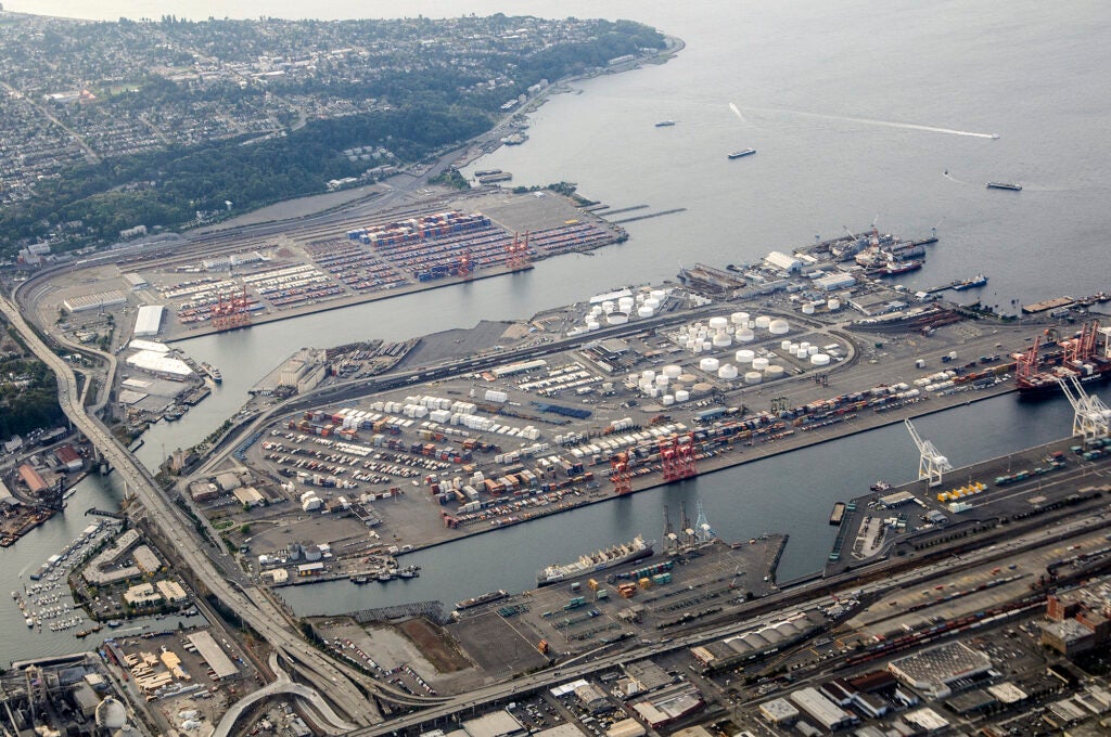 An aerial view of an industrial port area surrounded by channels of water.
