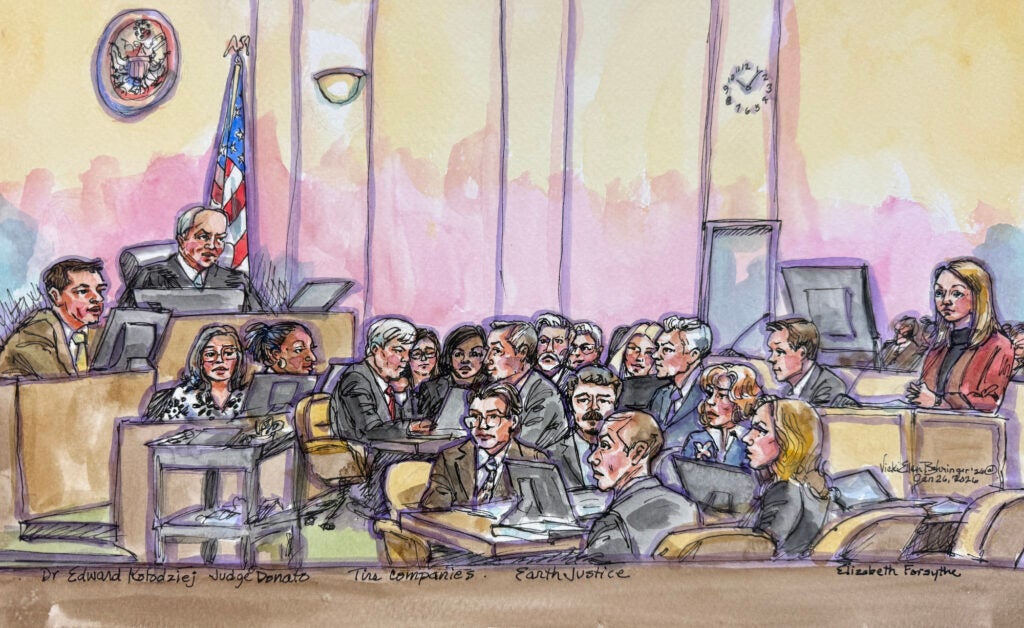 A color courtroom sketch featuring people on the stand and judge on the left, the parties in the middle and an attorney on the right asking questions.