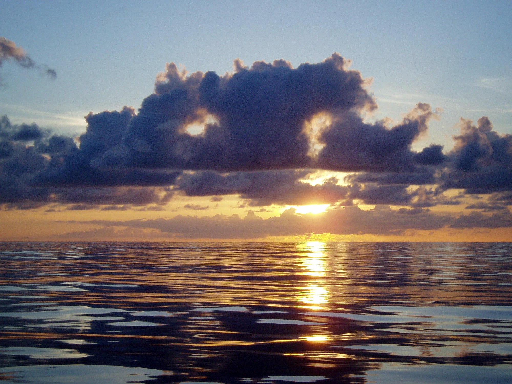 A tropical sunset over a placid sea. Hawaii, Papahanaumokuakea Marine National Monument. (Claire Fackler/CINMS/NOAA)