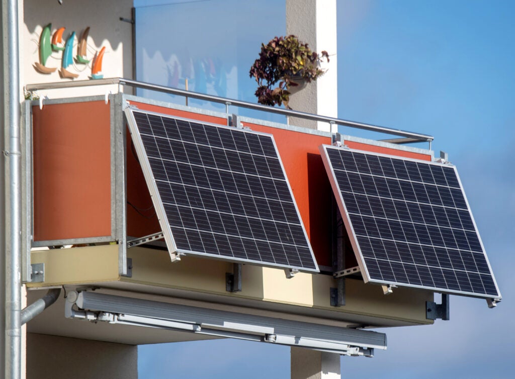 Solar modules hang on a balcony.
