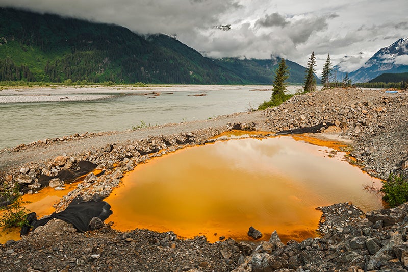 Acid drainage from the Tulsequah Chief Mine discolors a leaking containment pond next to the Tulsequah River in British Columbia, Canada, in 2013.
(Photo courtesy of Chris Miller / Trout Unlimited)