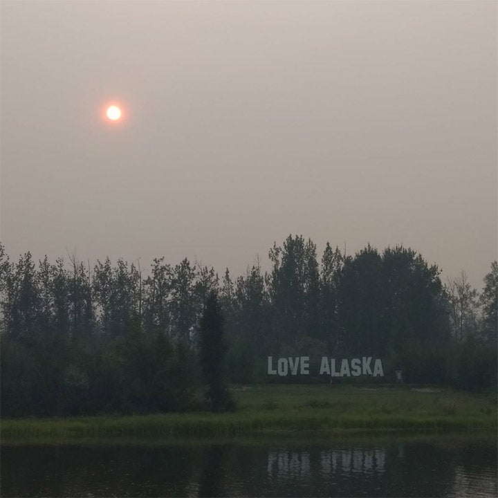 Smoke obscures the sun along the Chena River in Fairbanks on July 8, 2019. Record high temperatures in Alaska in early July worsened wildfires burning throughout the state.