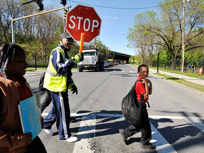 School crossing guard Be Be White stops traffic on South Pearl Street for children returning home from school. White, who has lived in Ezra Prentice Homes for 12 years, is among the residents who attended meetings against the Global’s project and joined the legal case against the company’s planned expansion.
(Earthjustice Photo)