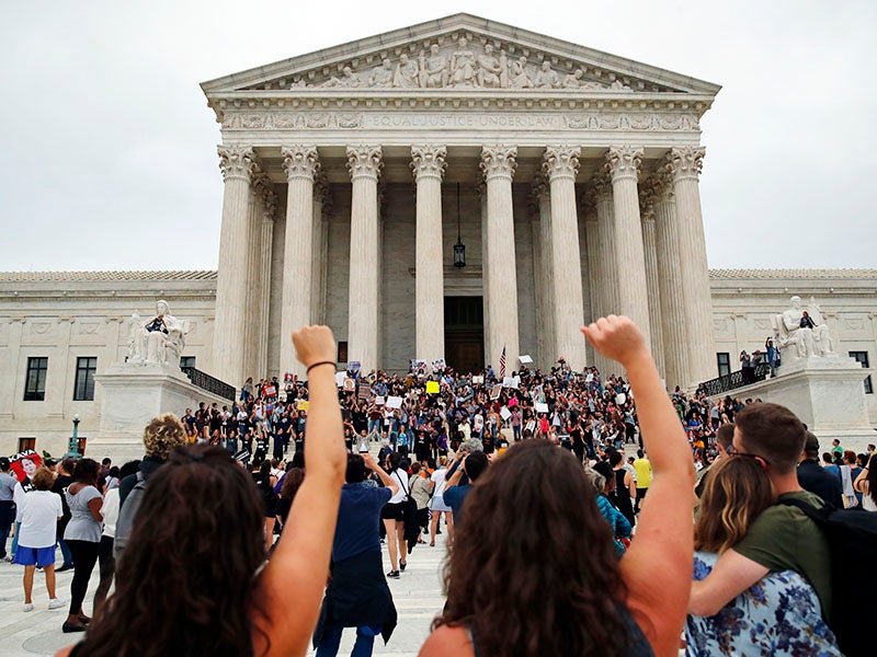Activists protest outside the Supreme Court as Justice Brett Kavanaugh is sworn in.