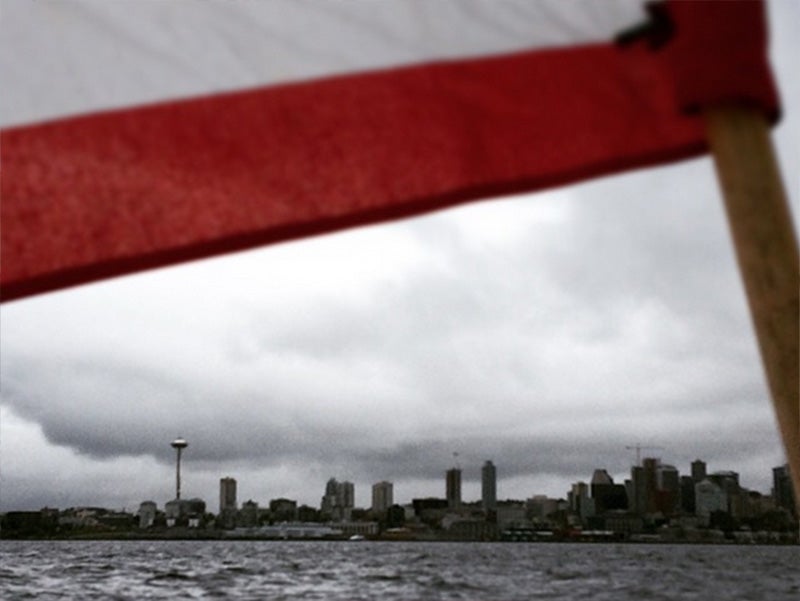 A flag flies on Seattle&#039;s waterfront.