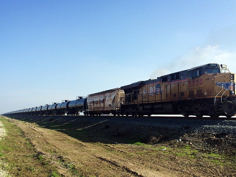 An oil train moves through California's Central Valley. The newly opened Bakersfield Crude Terminal has the capacity to receive two 100-car unit trains a day. (Download image for media use)(Elizabeth Forsyth / Earthjustice)