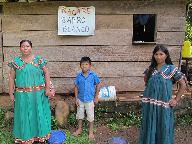 Weni Bagama and two of her children, whom the Barro Blanco dam will force from their land.  The sign says “No Barro Blanco” in the indigenous Ngäbe language. Bagama is a Ngäbe leader of the Movimiento 10 de Abril, a community-based movement defending the river from development projects.
(Abby Rubinson / Earthjustice)