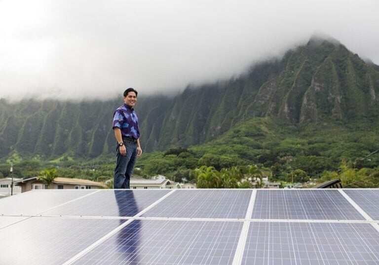 Earthjustice Managing Attorney Isaac Moriwake surveys rooftop solar