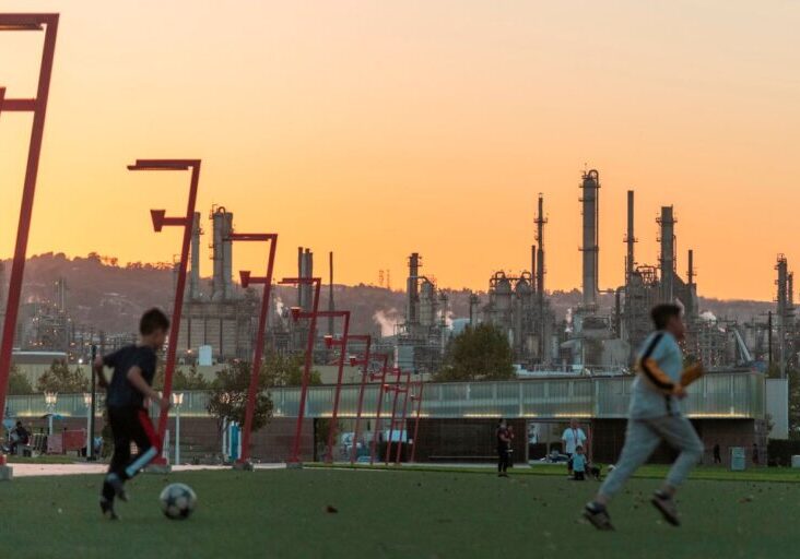 Kids play soccer near the Phillips 66 refinery in Wilmington, Calif.