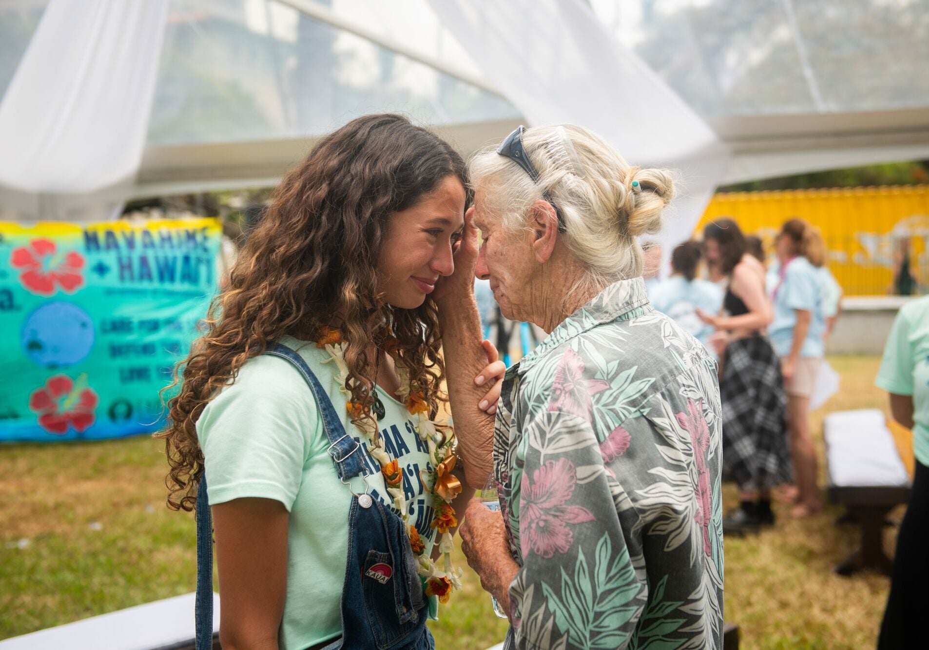 Youth plaintiff Kalā W. shares a moment with an elder after the announcement of the groundbreaking settlement agreement in the Navahine v. Hawai’i Department of Transportation lawsuit.