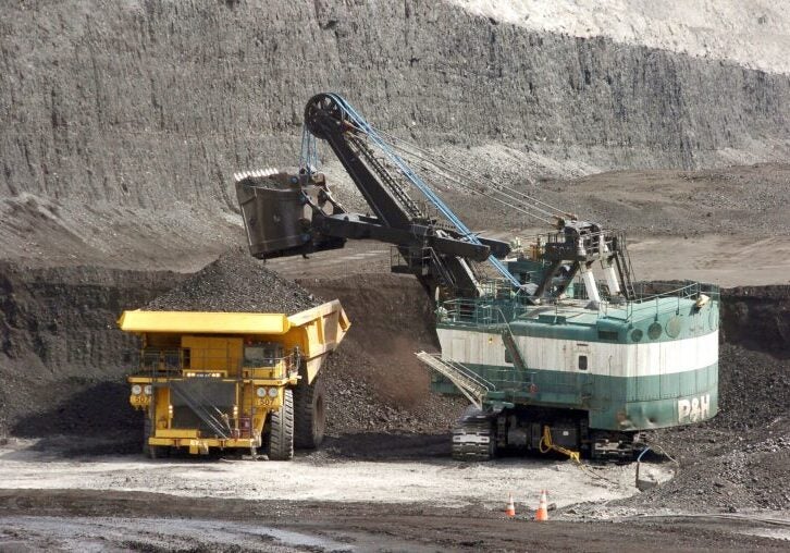 A mechanized shovel loads a haul truck that can carry up to 250 tons of coal.