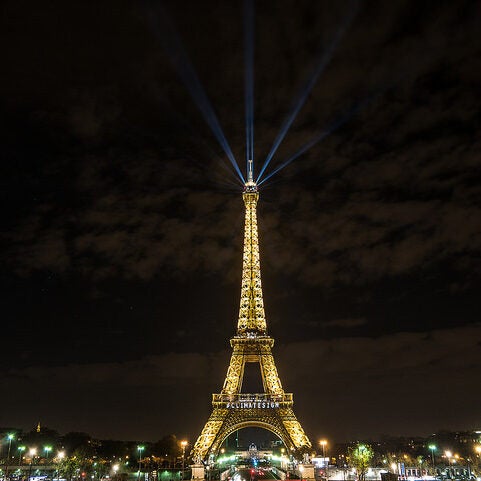 On the closing days of the Paris climate talks, an auspicious sign is illuminated on the Eiffel Tower.