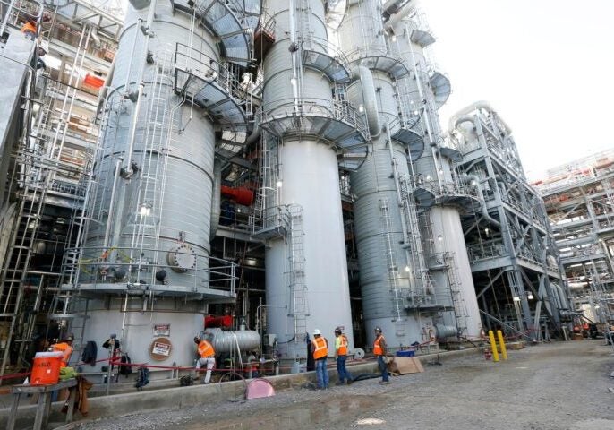 Employees work on a section of the Mississippi Power Co. carbon capture plant in DeKalb, Miss. (Rogelio V. Solis / AP)