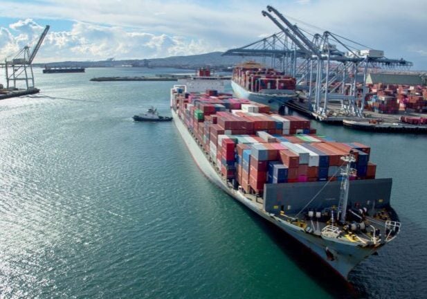 Drone shot of a massive container ship arriving in the Port of Long Beach, California.