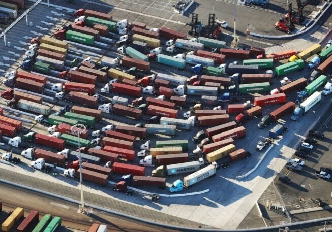 An aerial view of shipping containers attached to trucks