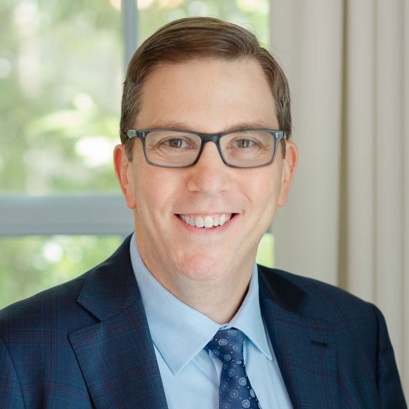 Portrait of Stephen Vladeck smiling and looking at the camera.
