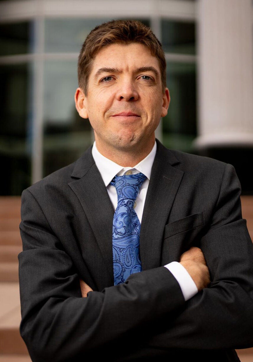 Stu Gillespie, supervising senior attorney for Earthjustice's Rocky Mountain office, stands outside Utah's Third District Court in Salt Lake City, with his arms crossed, looking directly at the camera.