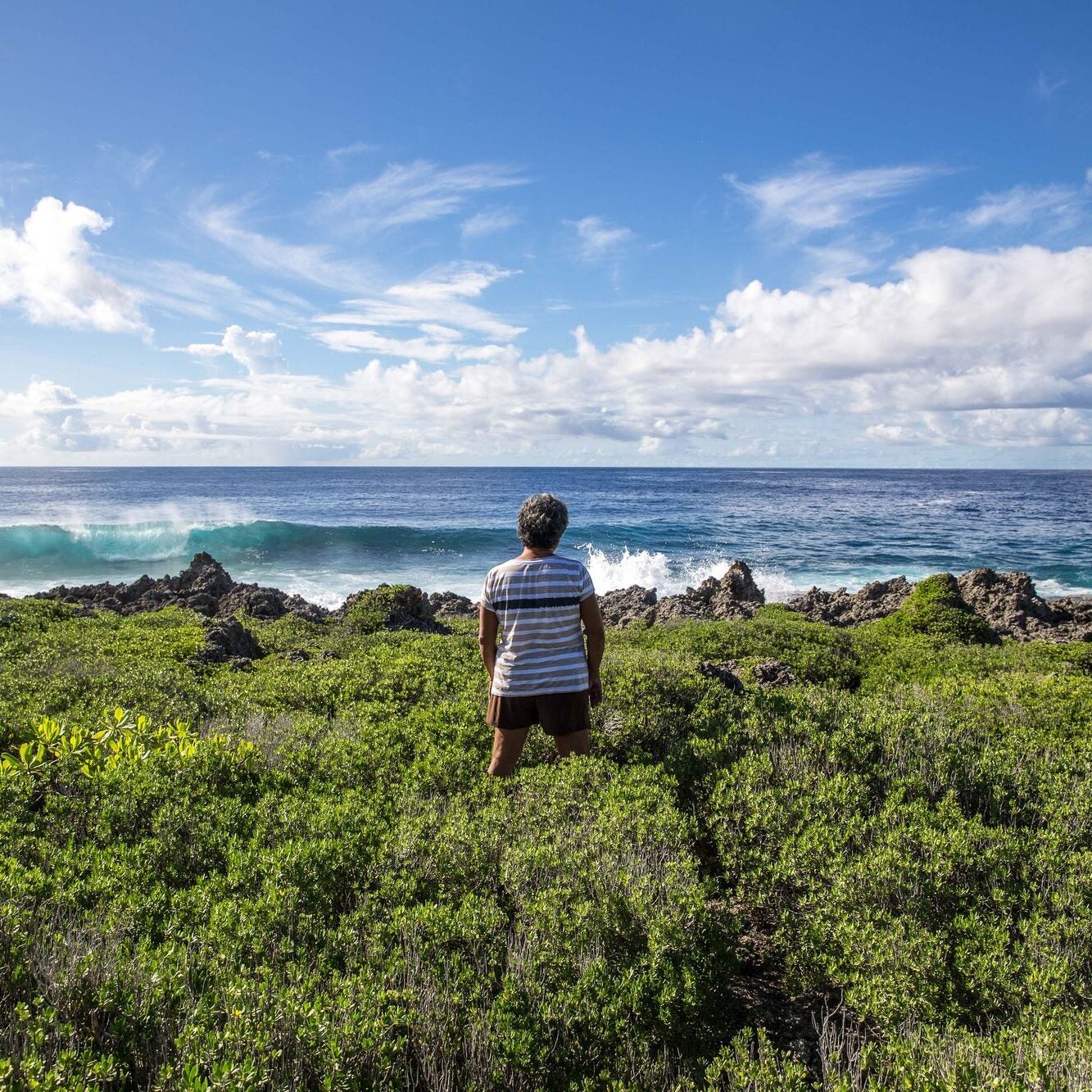 A member of the Tinian Women Association looks out onto the Pacific Ocean from the island of Tinian.