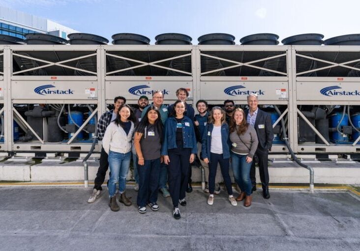 Coalition standing in front of industrial heat pumps at the UCI Health-Irvine hospital.