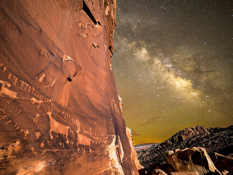 The night sky illuminates a wall of petroglyphs at Utah&#039;s Bears Ears National Monument.