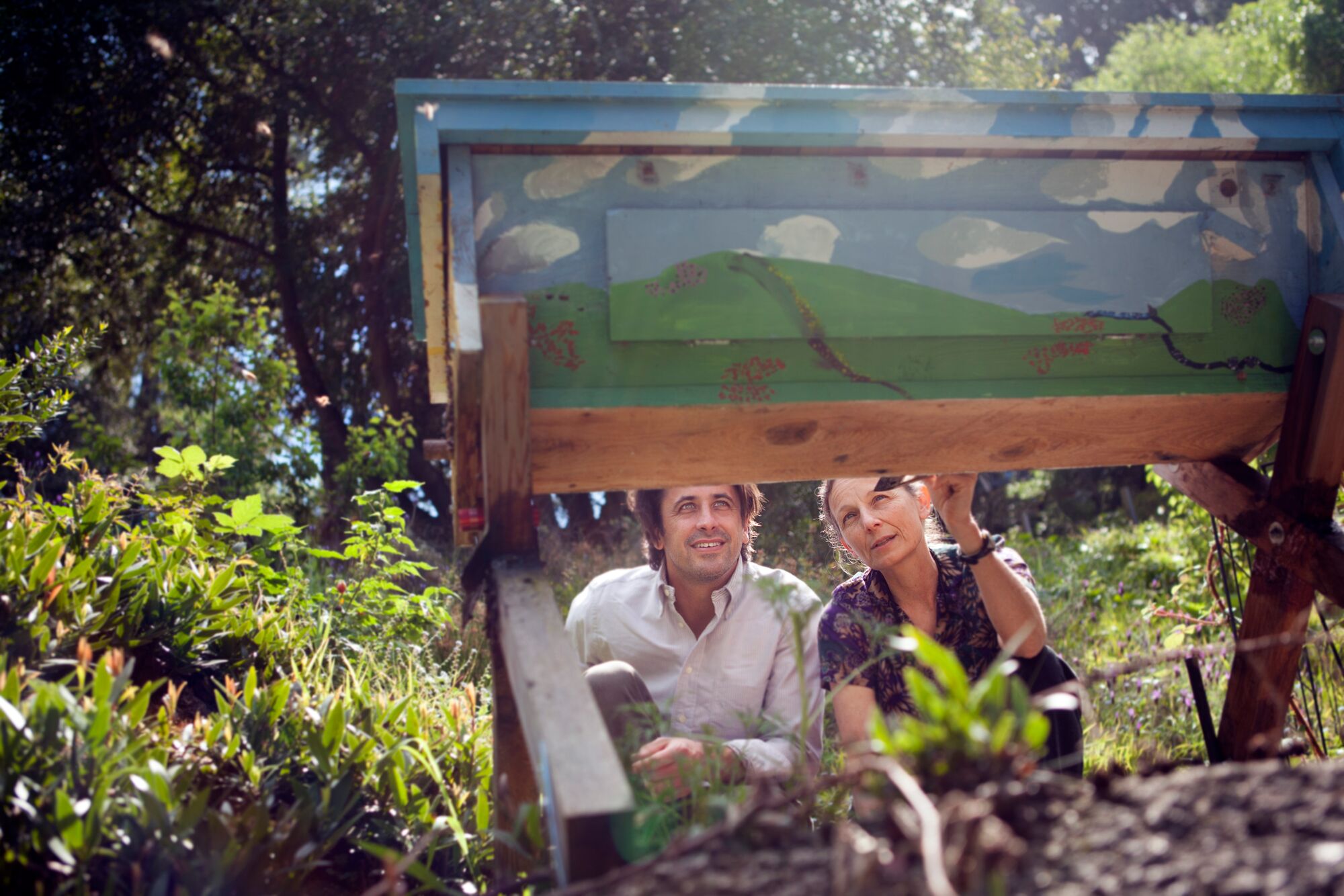 Dr. Susan Kegley shows Earthjustice attorney Greg Loarie a bee box in the backyard of her home in California.