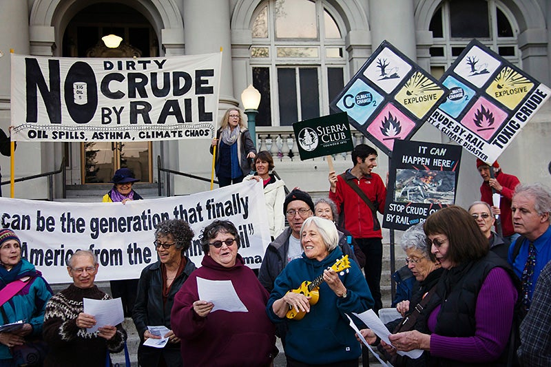 Residents rally outside Berkeley City Hall to show opposition to a proposed crude by rail project.