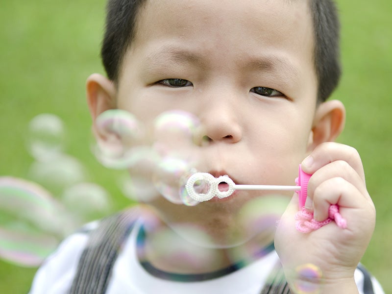 A child blowing bubbles.