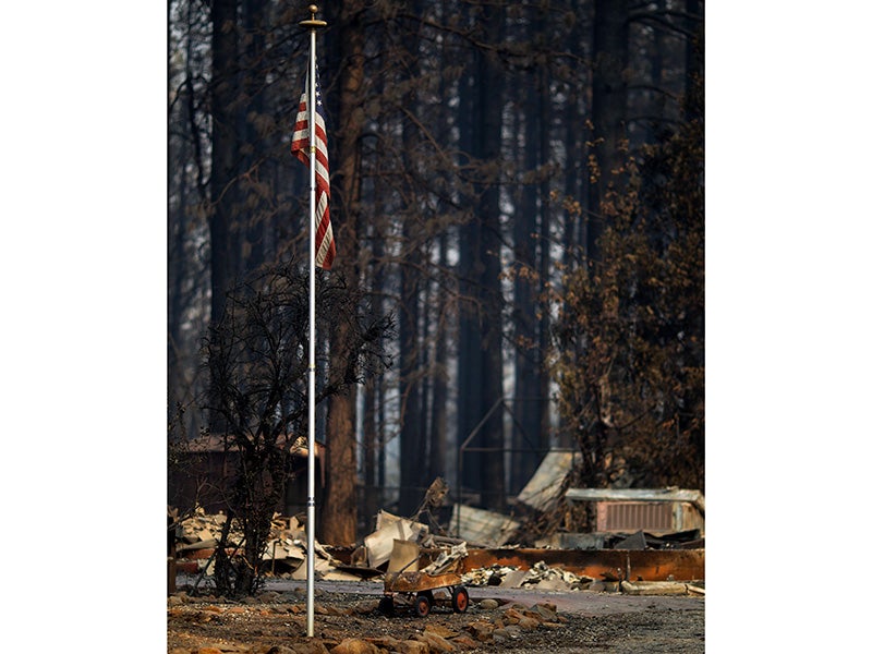 A U.S. flag remains standing in a Paradise, California, neighborhood, Nov. 17, 2018, days after the Camp Fire overran the town.