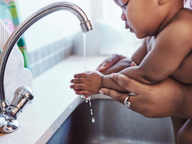 A baby washes hands.