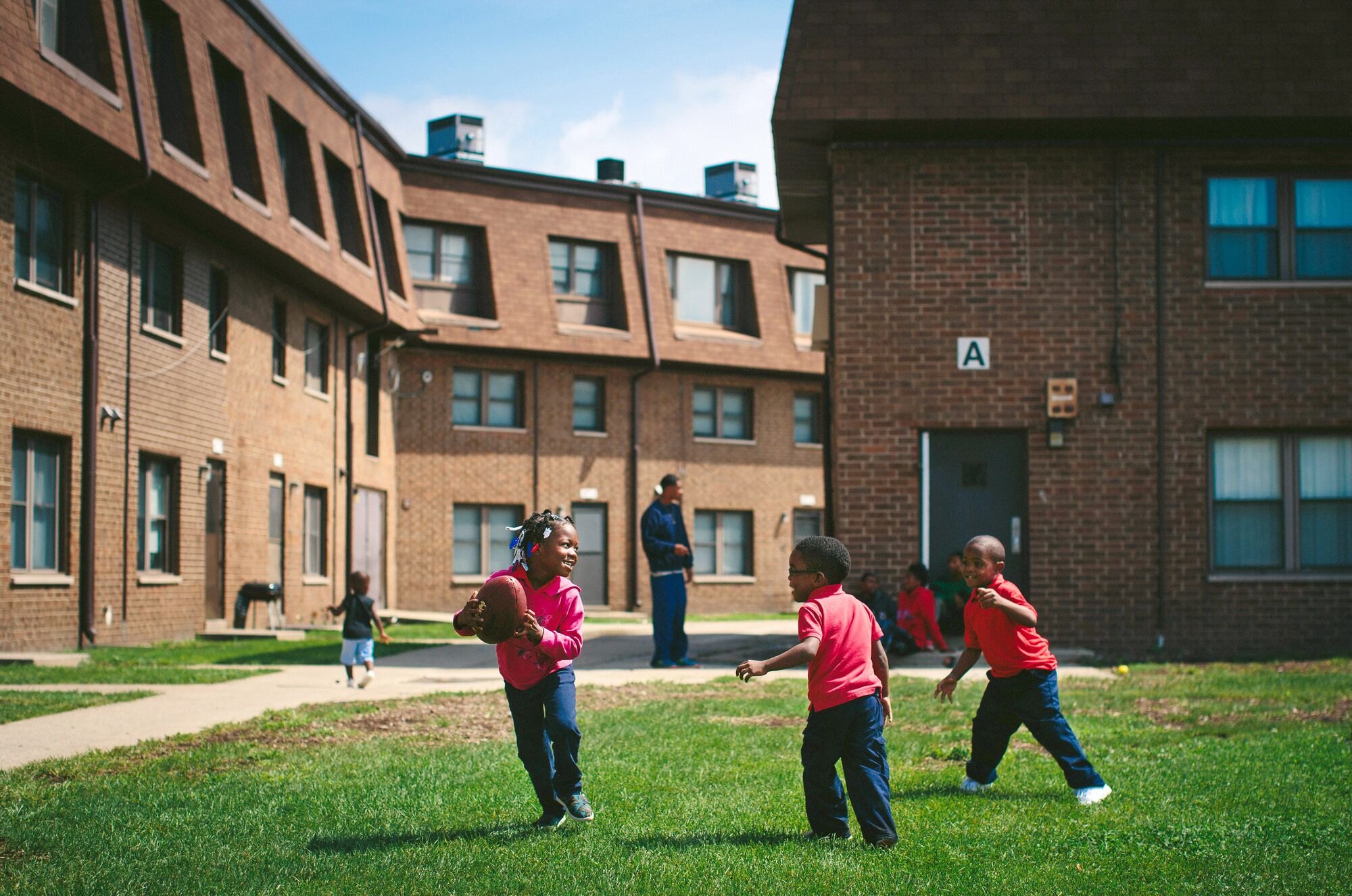 Photo of children playing in a yard at the West Calumet Housing Complex in East Chicago, Ind., on August 24, 2016.