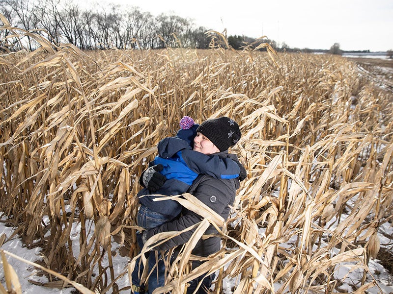 Bonnie Wirtz with son in a field in rural Minnesota.