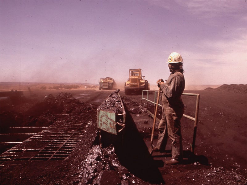 A Navajo workman covers his face at the Peabody Coal Company in Black Mesa, Arizona, May, 1972.