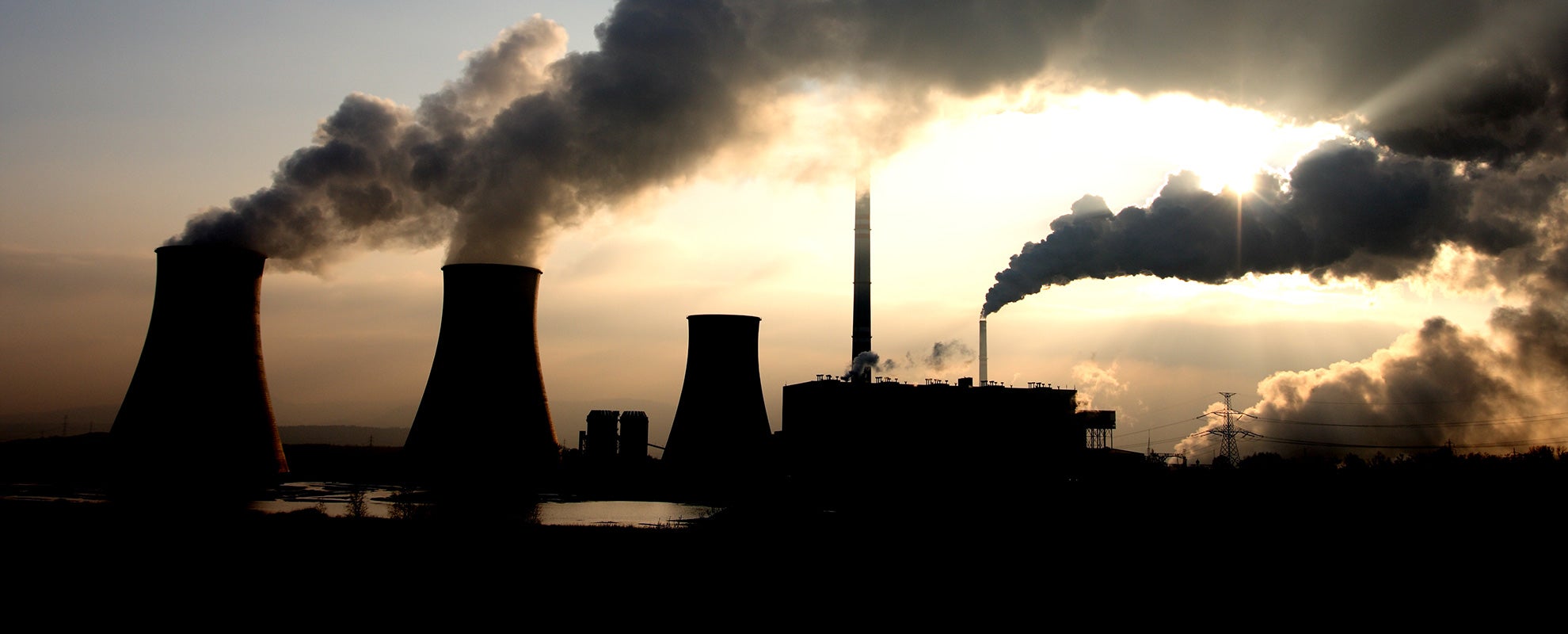 The sun breaks through smoke from a coal-fired power plant.