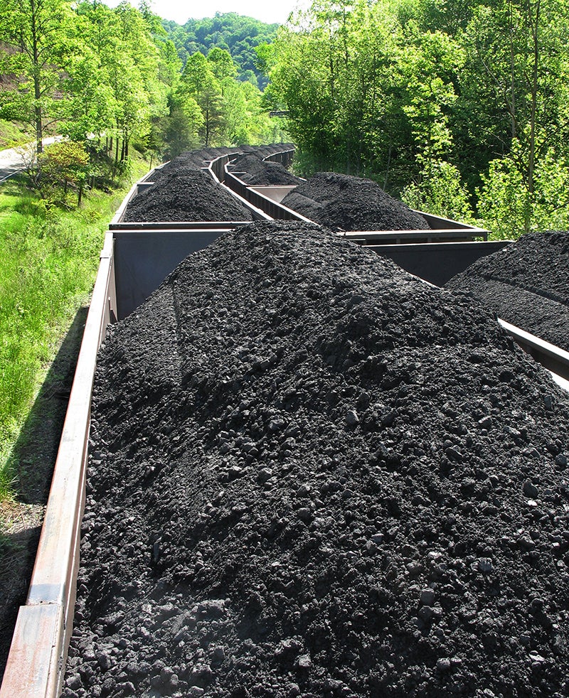 Coal piled in open railroad cars