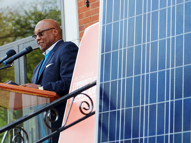 Pastor Marcus Harris of the Dupont Park Seventh Day Adventist Church speaks at an event to celebrate solar panels being installed on the church.