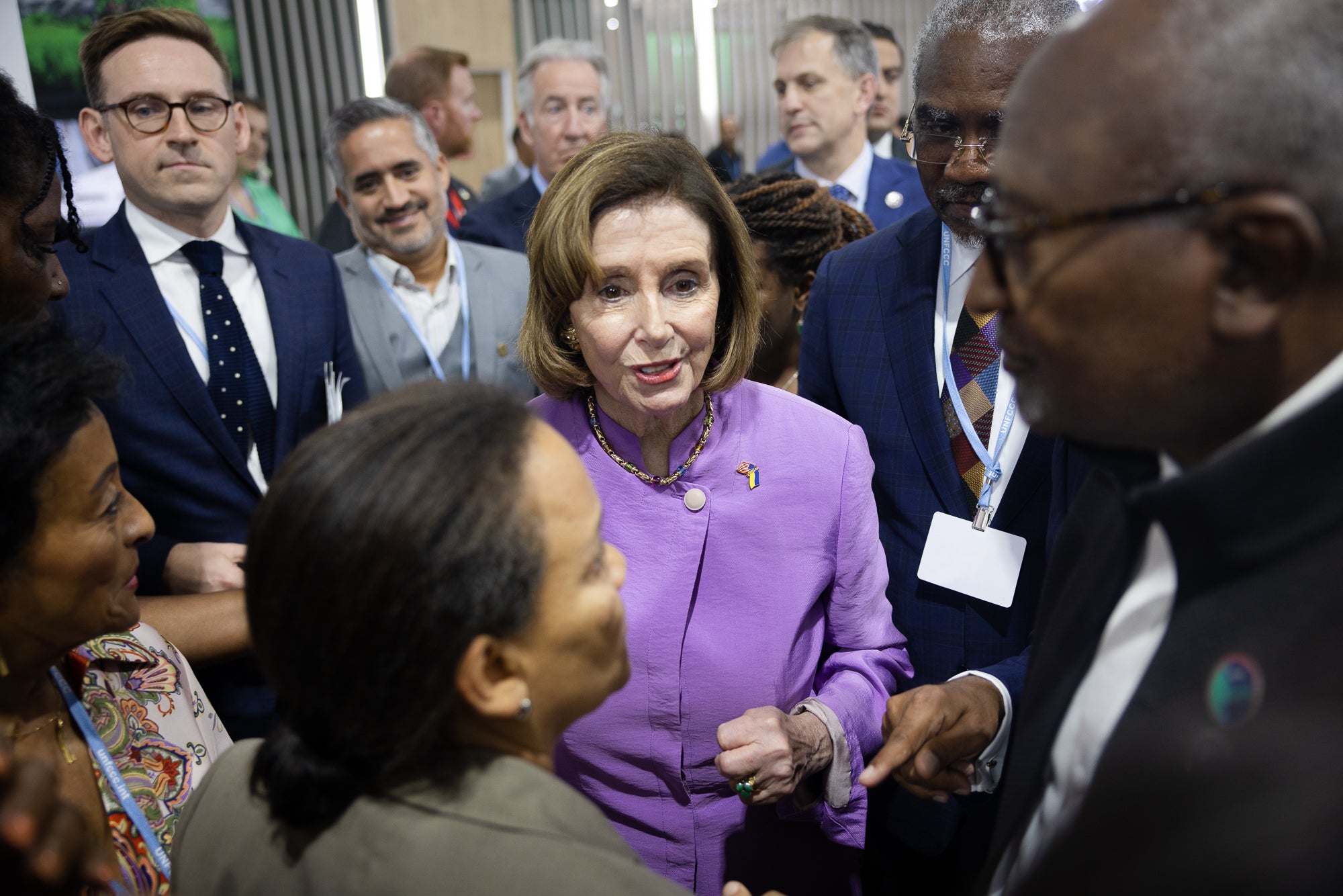 Then-U.S. House Speaker Nancy Pelosi, center, talks with Earthjustice board member and Puerto Rico-based lawyer Ruth Santiago, foreground, and Dr. Robert Bullard, far right, at the Climate Justice Pavilion. As COP27 progressed, more and more politicians and leaders came to the Climate Justice Pavilion to attend panels and meet with participants.