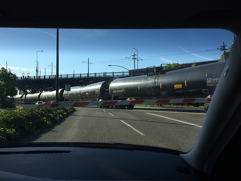 An oil train travels through the city of Portland, OR on April 29, 2014. Global Partners LP has been moving highly volatile Bakken crude oil from North Dakota on trains (prone to explosion and fire) through Portland and other towns, with no federal permit controls.
(Photo courtesy of Sam Beebe)